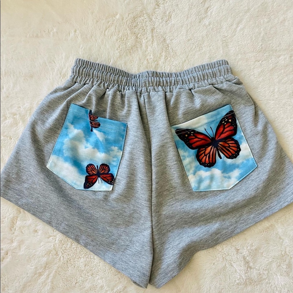 light grey sweat shorts with butterfly pattern!